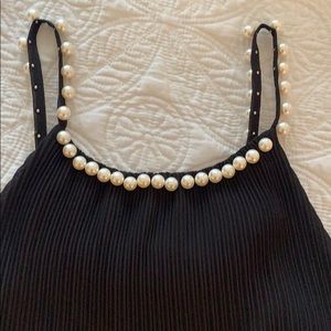 Plisse black top with pearl details. Made in Italy